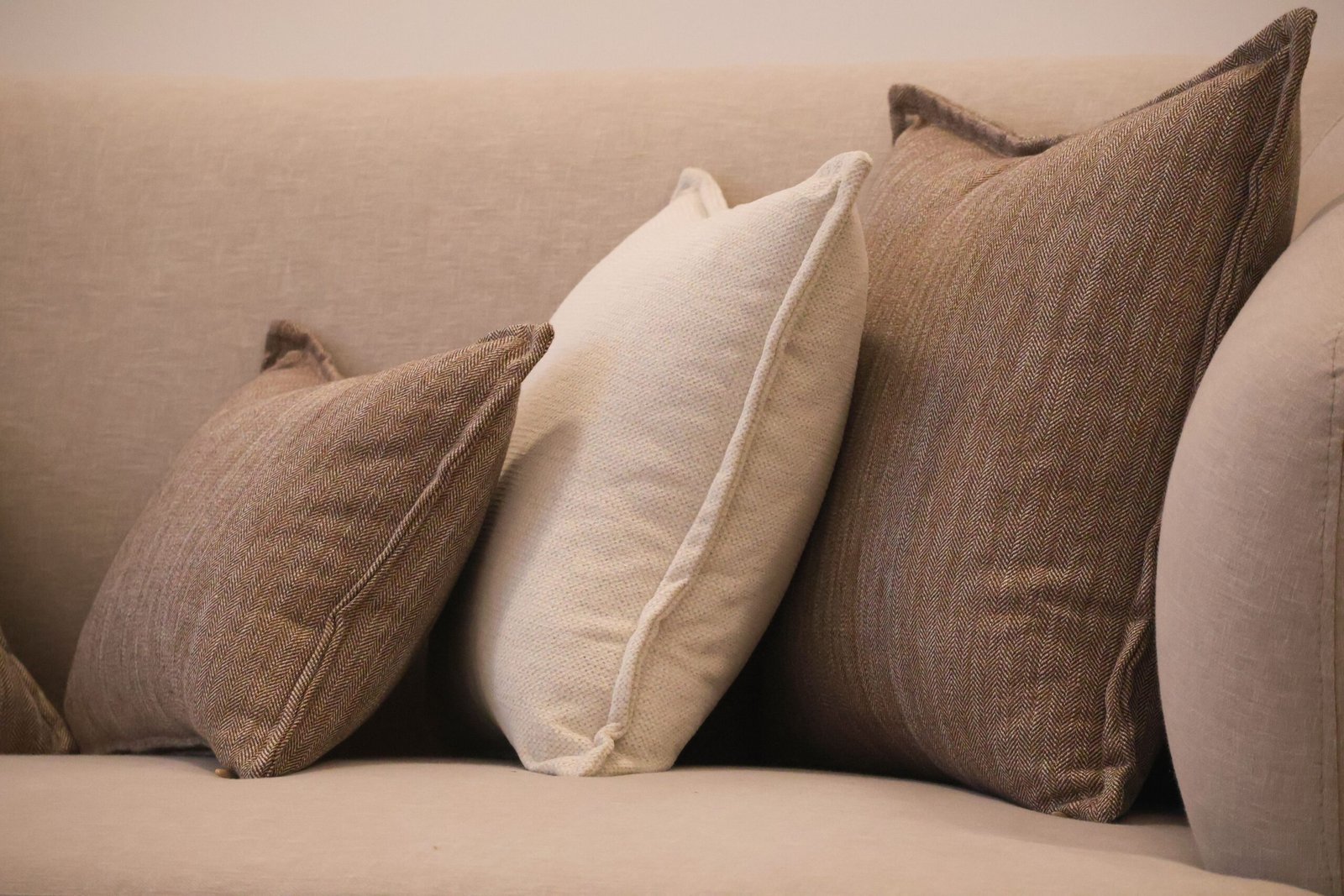 Layered neutral sofa cushions