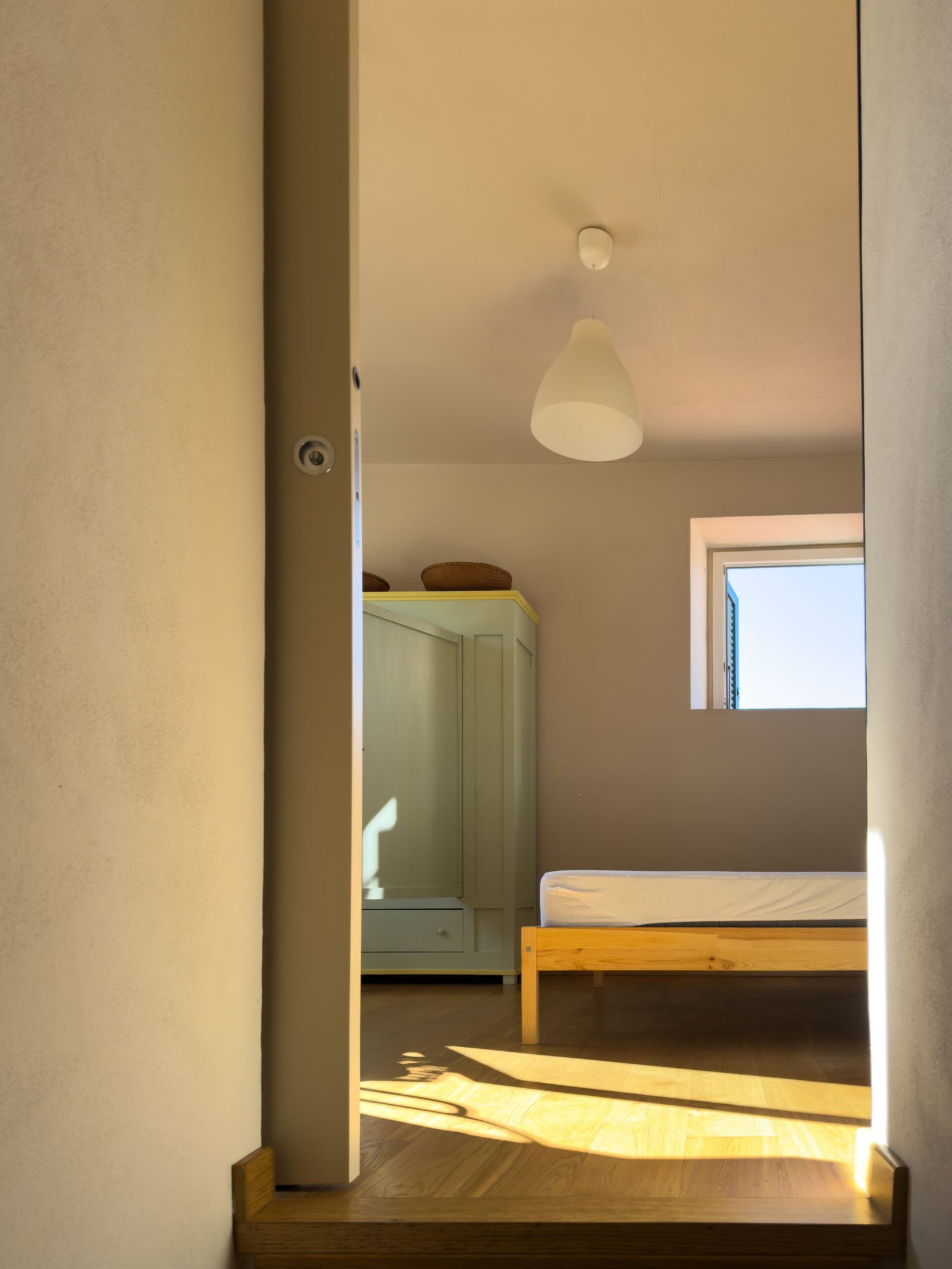 Compact bedroom with tall wardrobe