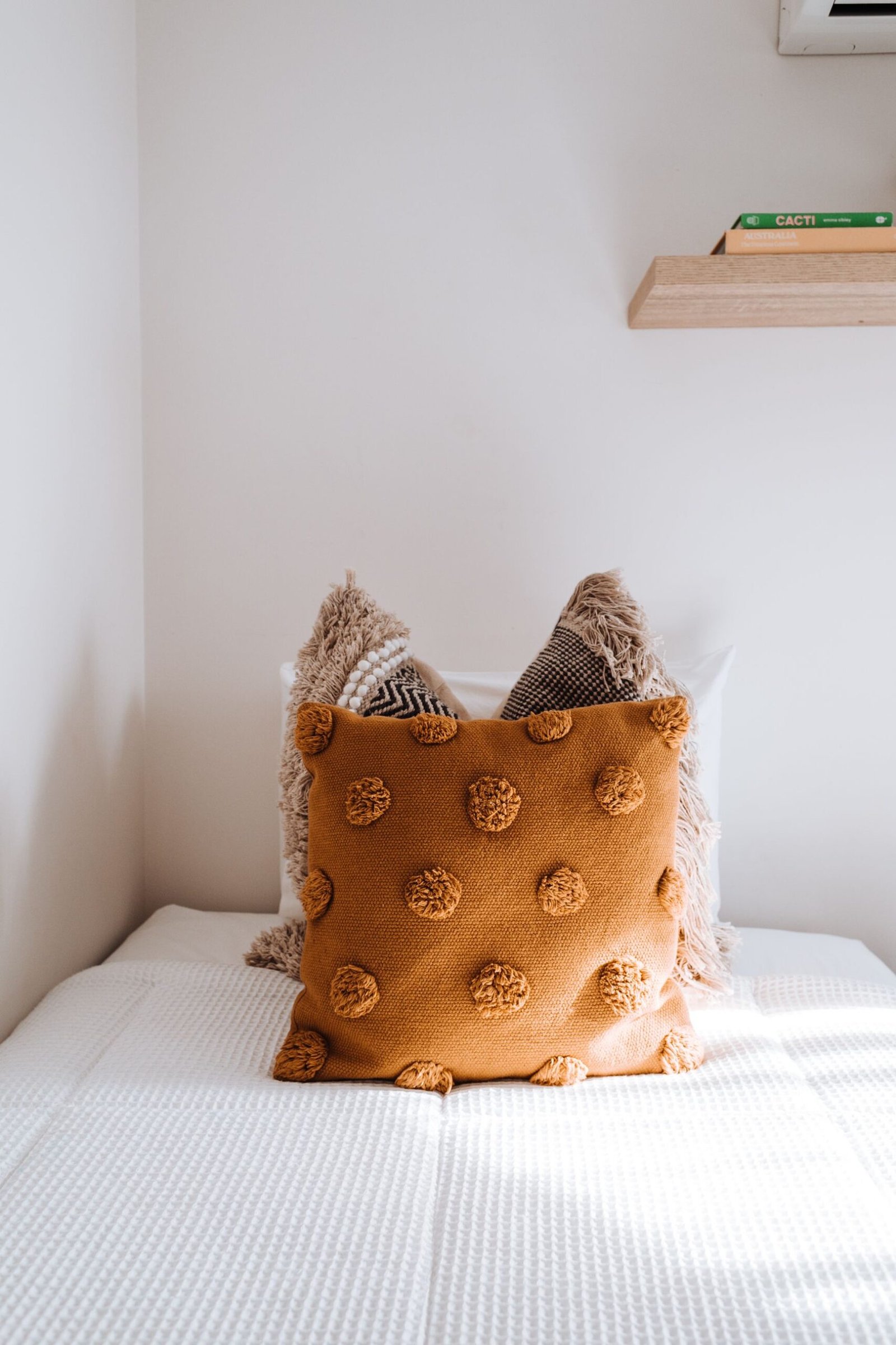 Limited accent cushions on neatly made bed
