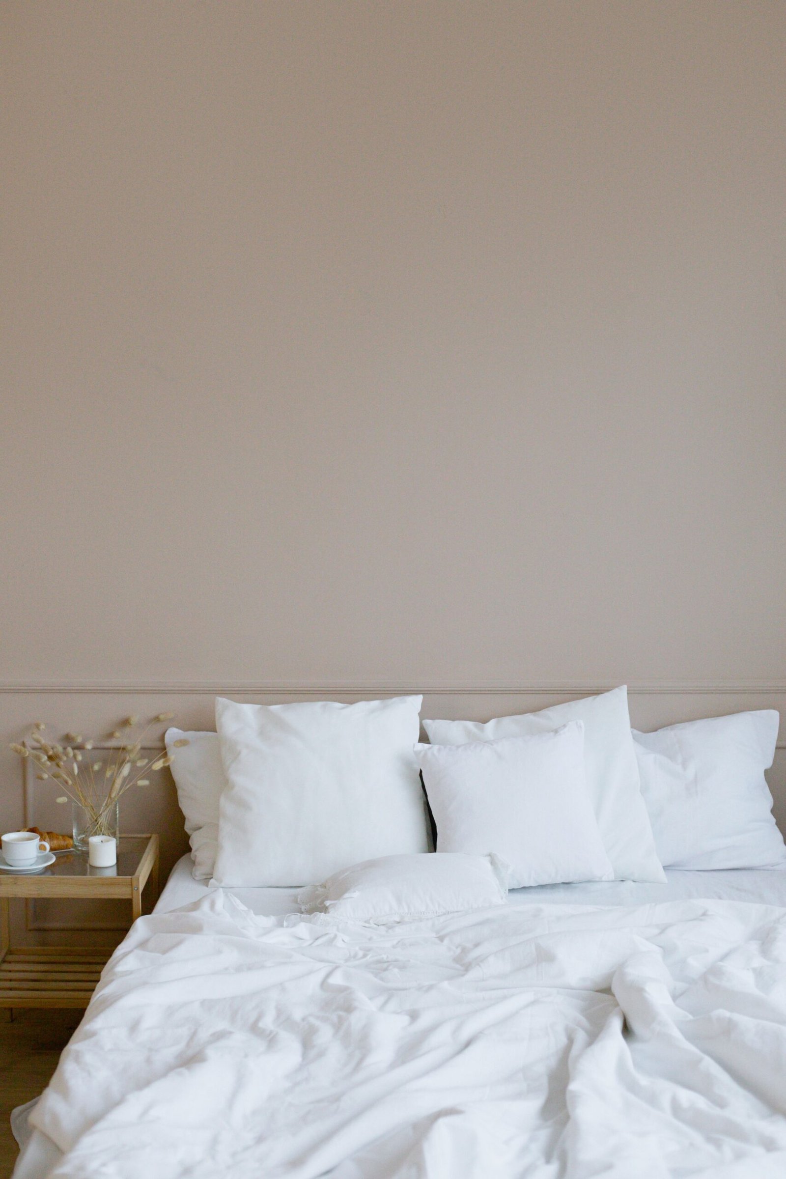 Neatly made bedroom with clear bedside surface