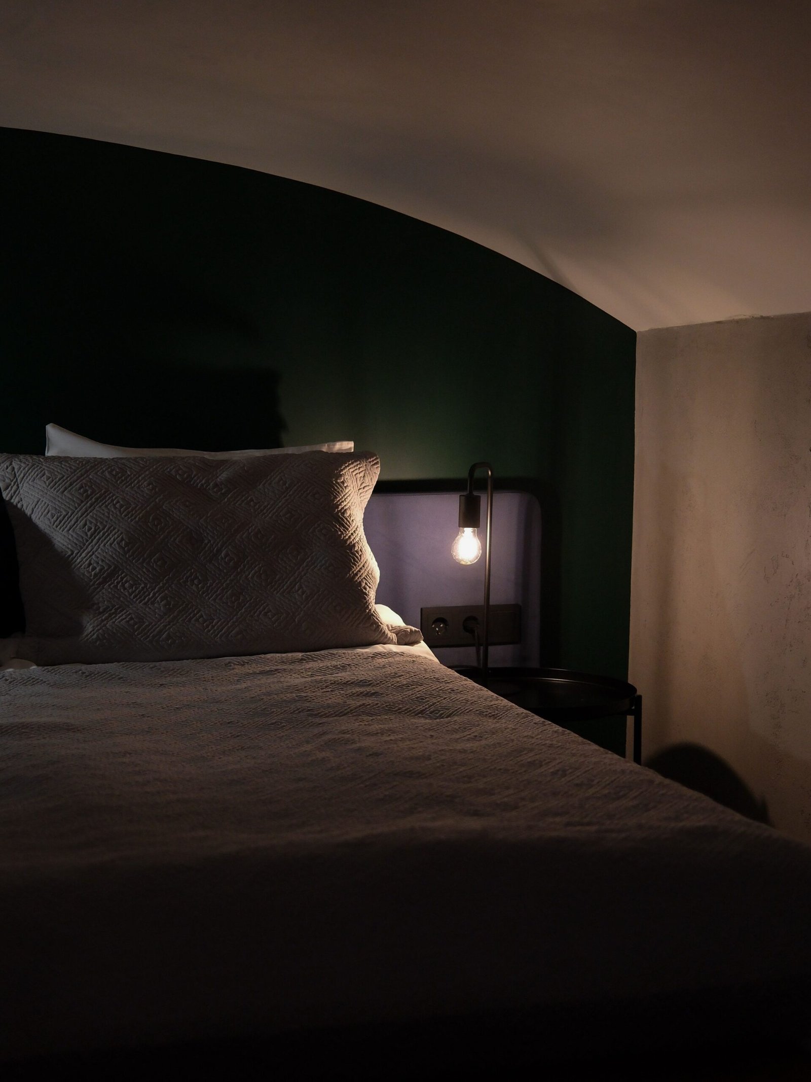Warm bedside lighting in cozy bedroom